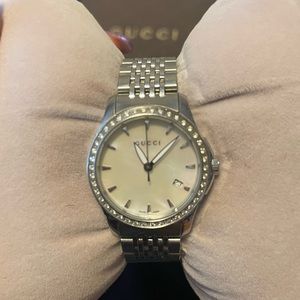 Gucci Timeless Watch, diamonds surrounding mother of pearl watch face